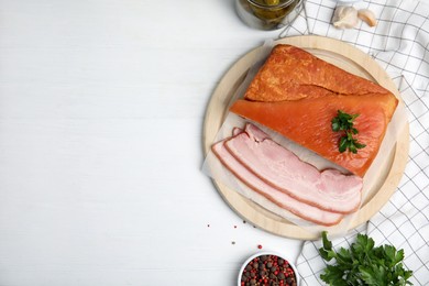 Photo of Flat lay composition with delicious smoked bacon on white wooden table, space for text