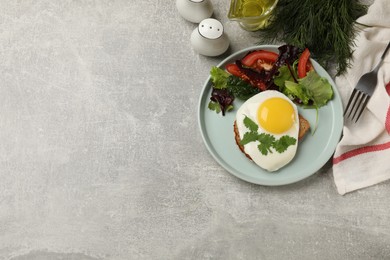 Photo of Delicious breakfast with fried egg and salad served on light grey table, flat lay. Space for text