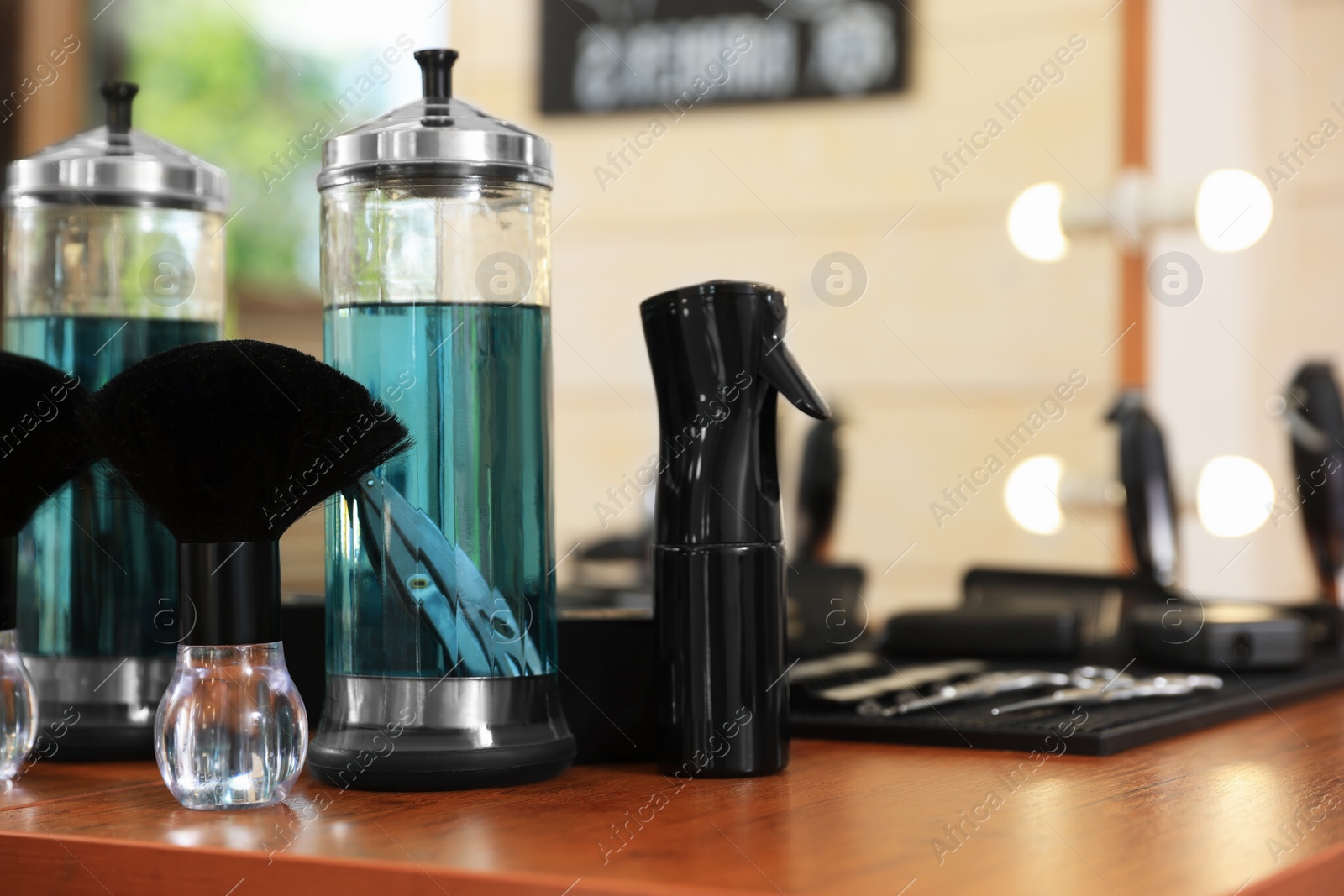 Photo of Stylish hairdresser's workplace with professional tools and cosmetic products in barbershop