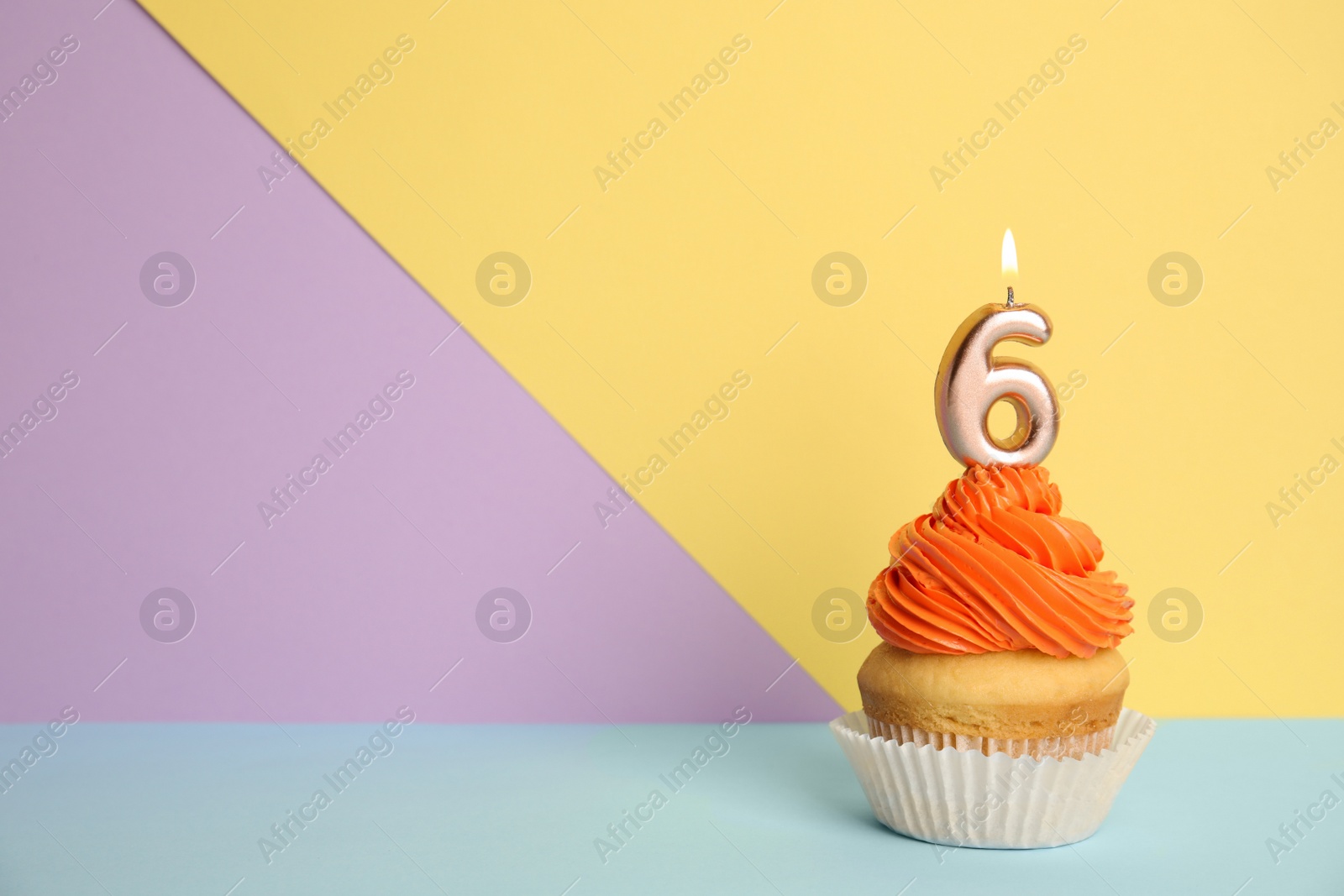 Photo of Birthday cupcake with number six candle on color background, space for text