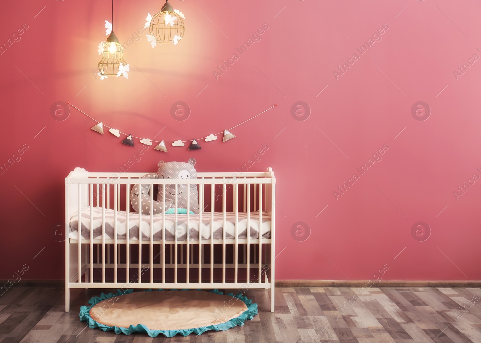 Photo of Modern baby room interior with crib near color wall