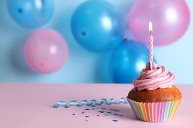 Photo of Delicious birthday cupcake on color background, space for text