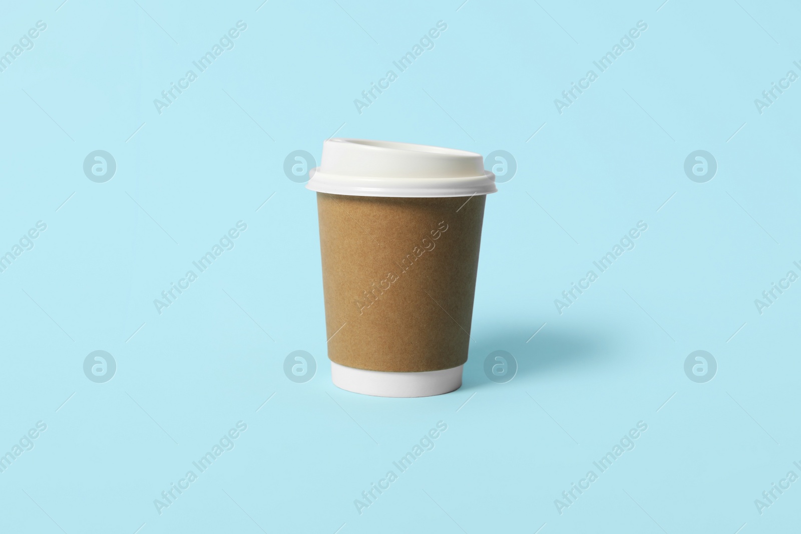 Photo of Takeaway paper coffee cup on light blue background