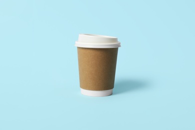 Photo of Takeaway paper coffee cup on light blue background