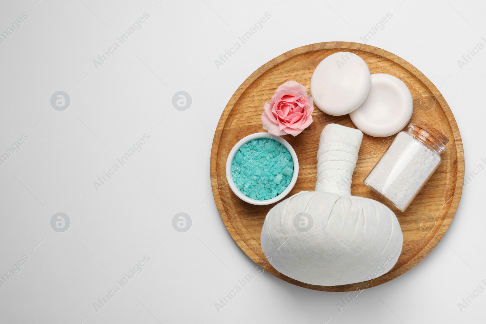 Photo of Beautiful spa composition with herbal massage bag and different care products on white background, top view. Space for text