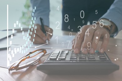 Image of Man with calculator working at table in office, closeup