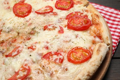 Delicious pizza Margherita on wooden table, closeup