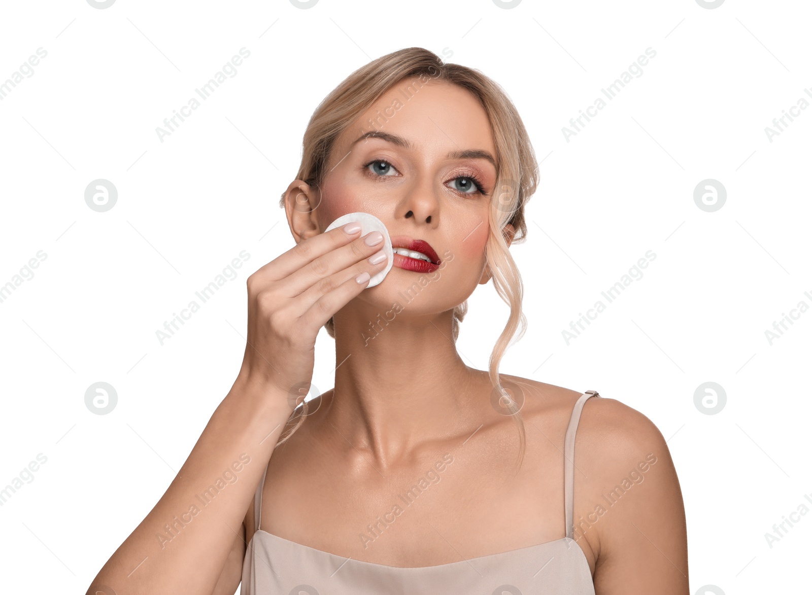 Photo of Beautiful woman removing makeup with cotton pad on white background