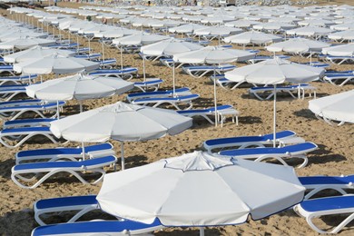 Many beach umbrellas and sunbeds on resort