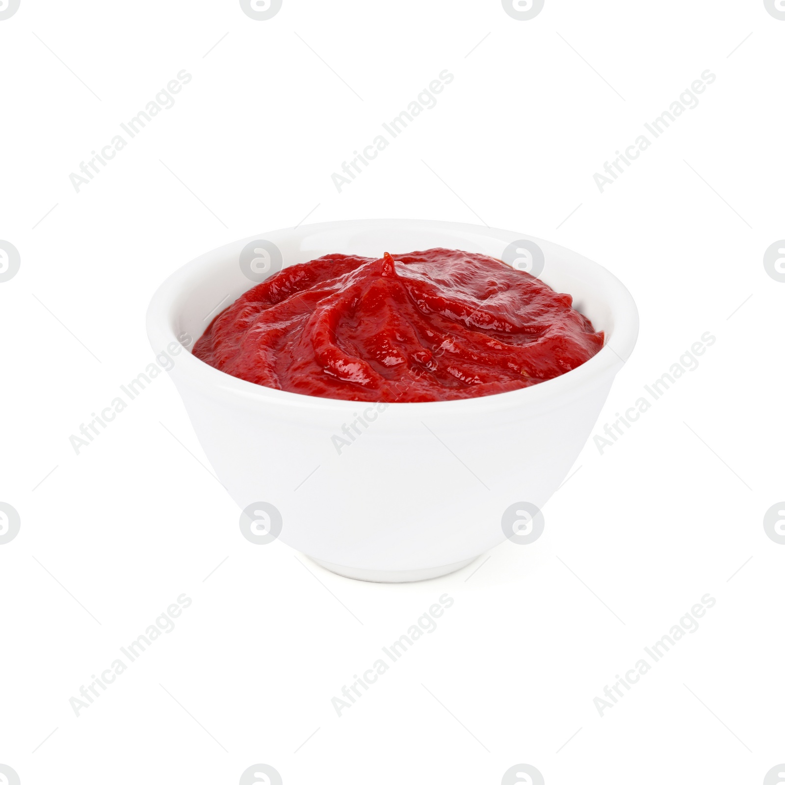 Photo of Organic ketchup in bowl isolated on white. Tomato sauce