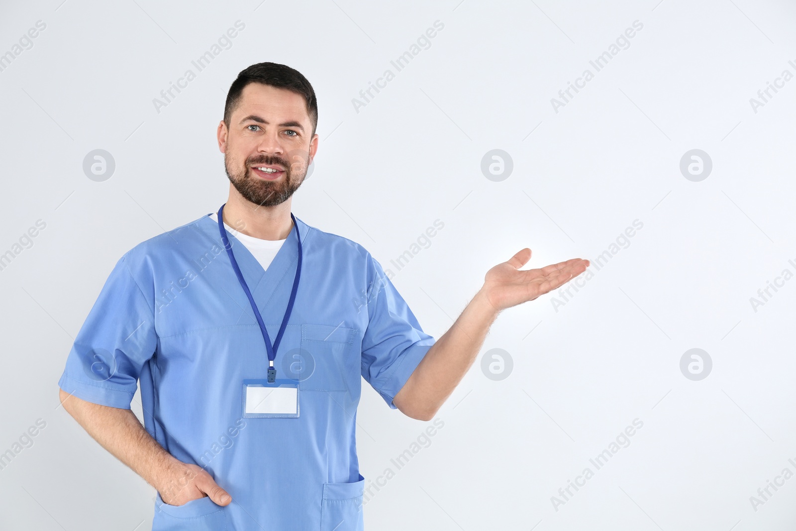 Photo of Portrait of mature doctor on white background