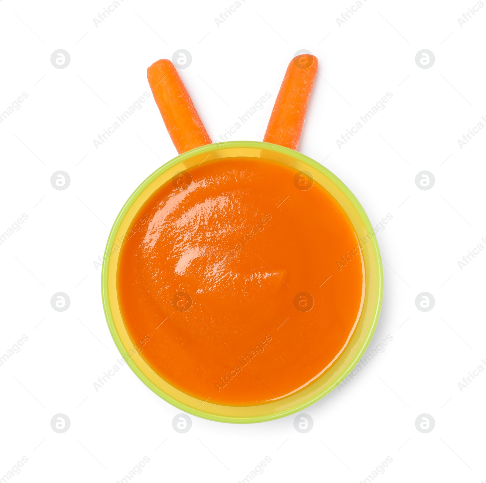 Photo of Delicious baby food in bowl and fresh carrots isolated on white, top view