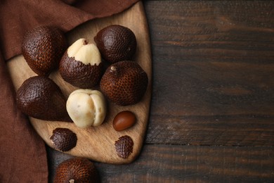 Fresh salak fruits on wooden table, top view. Space for text