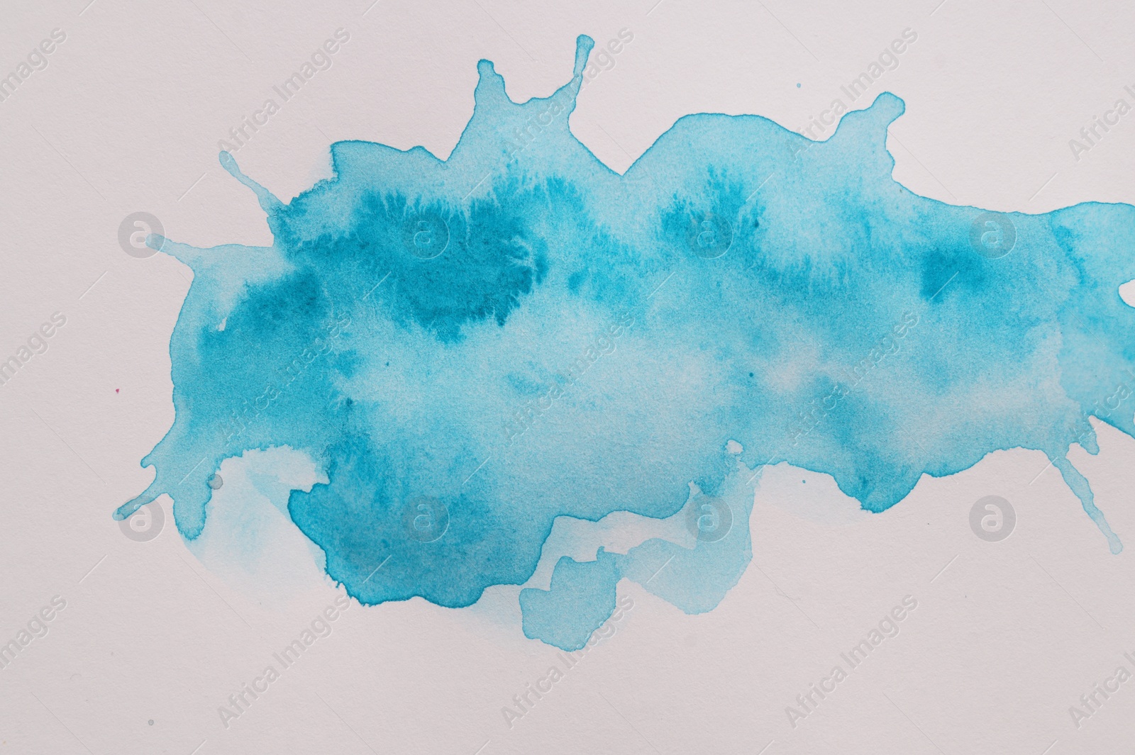 Photo of Light blue watercolor blots on white canvas, top view