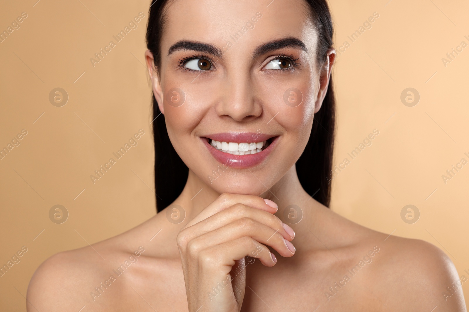 Photo of Portrait of attractive young woman on beige background. Spa treatment