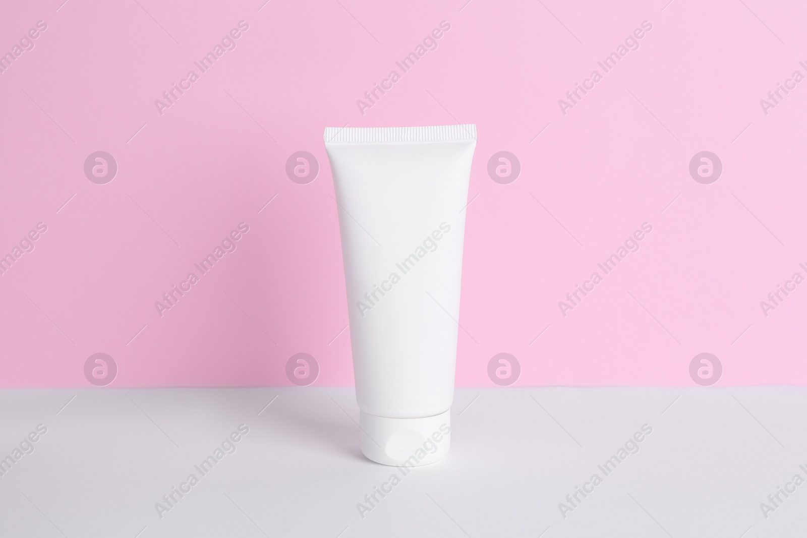 Photo of Tube of cream on color background. Body care product