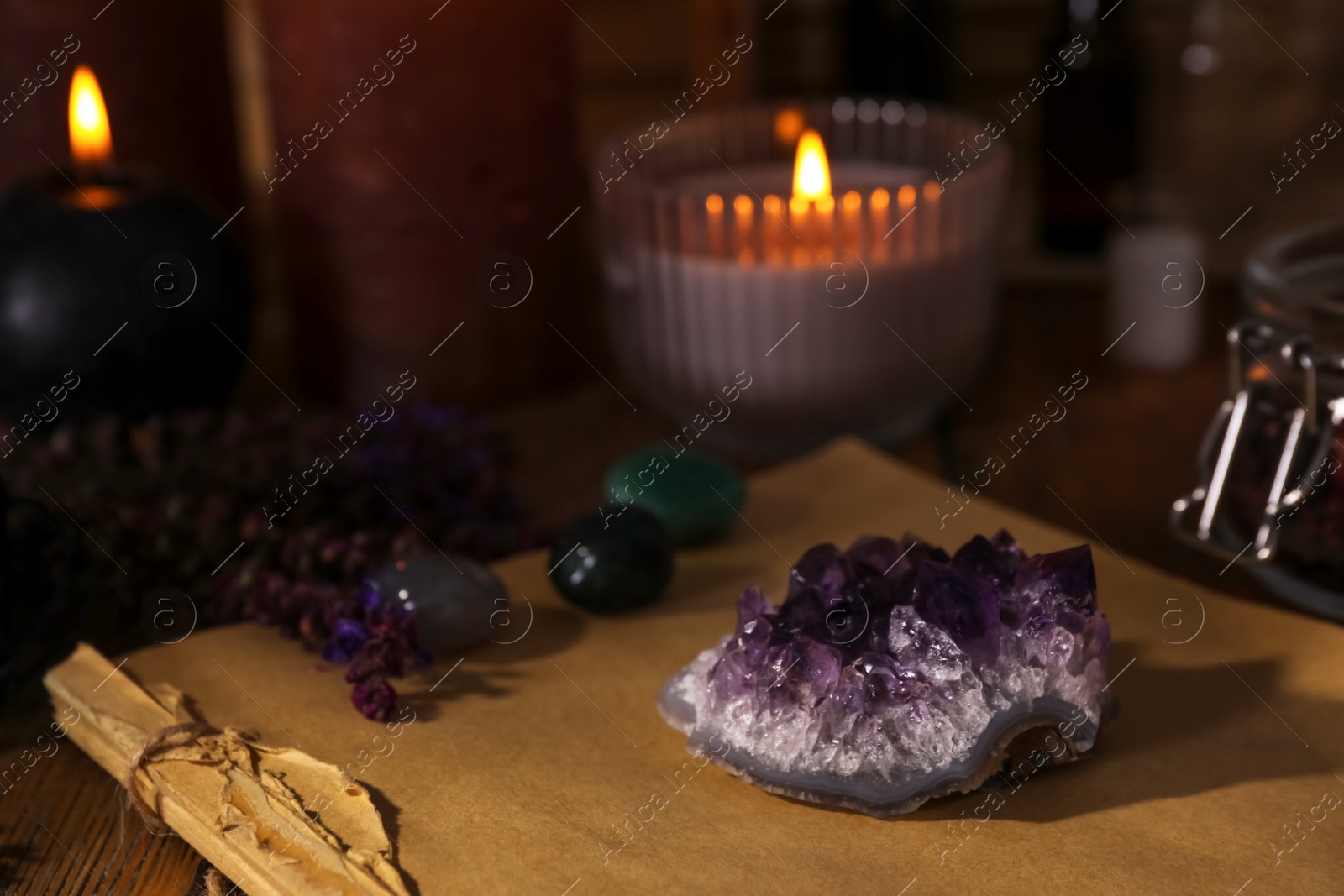 Photo of Composition with healing amethyst gemstone on table