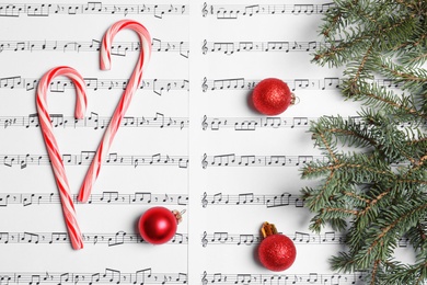 Composition with candy canes and Christmas balls on music sheets, top view