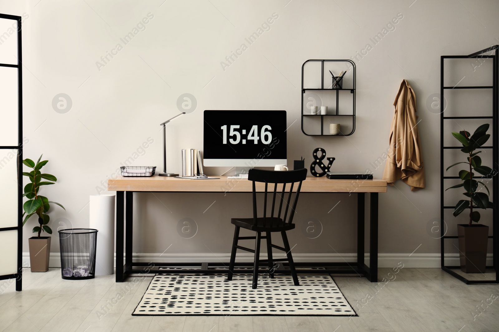 Photo of Modern workplace with computer in room. Interior design