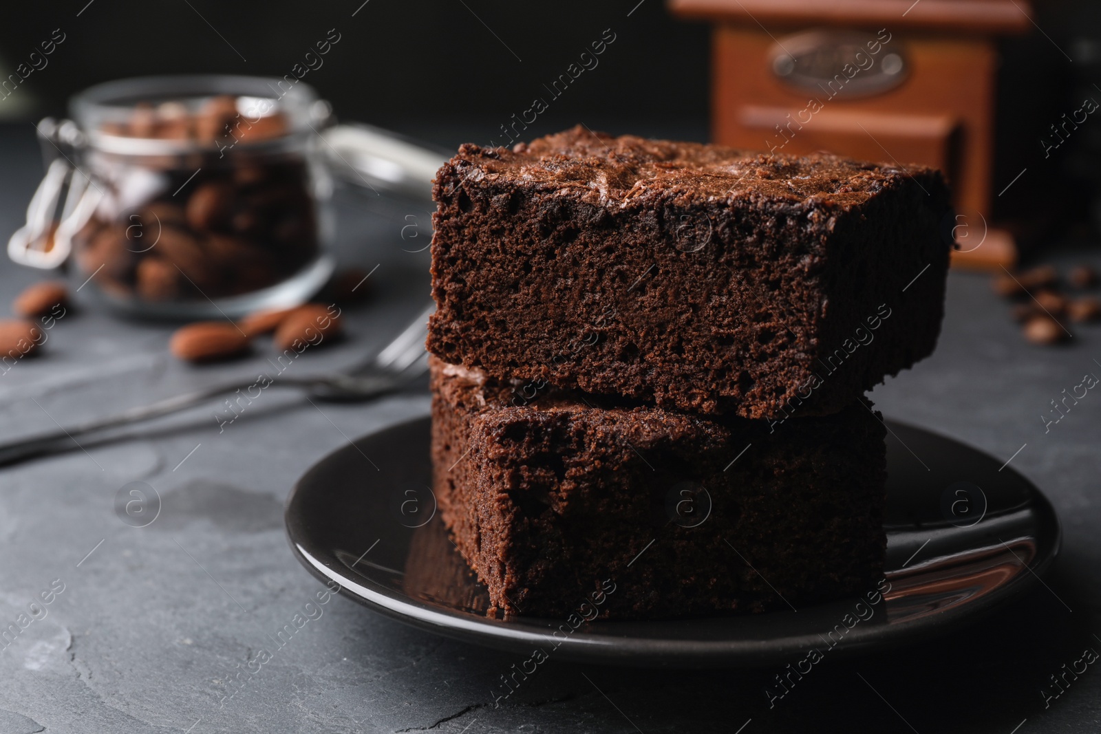 Photo of Plate with fresh brownies on grey table, space for text. Delicious chocolate pie