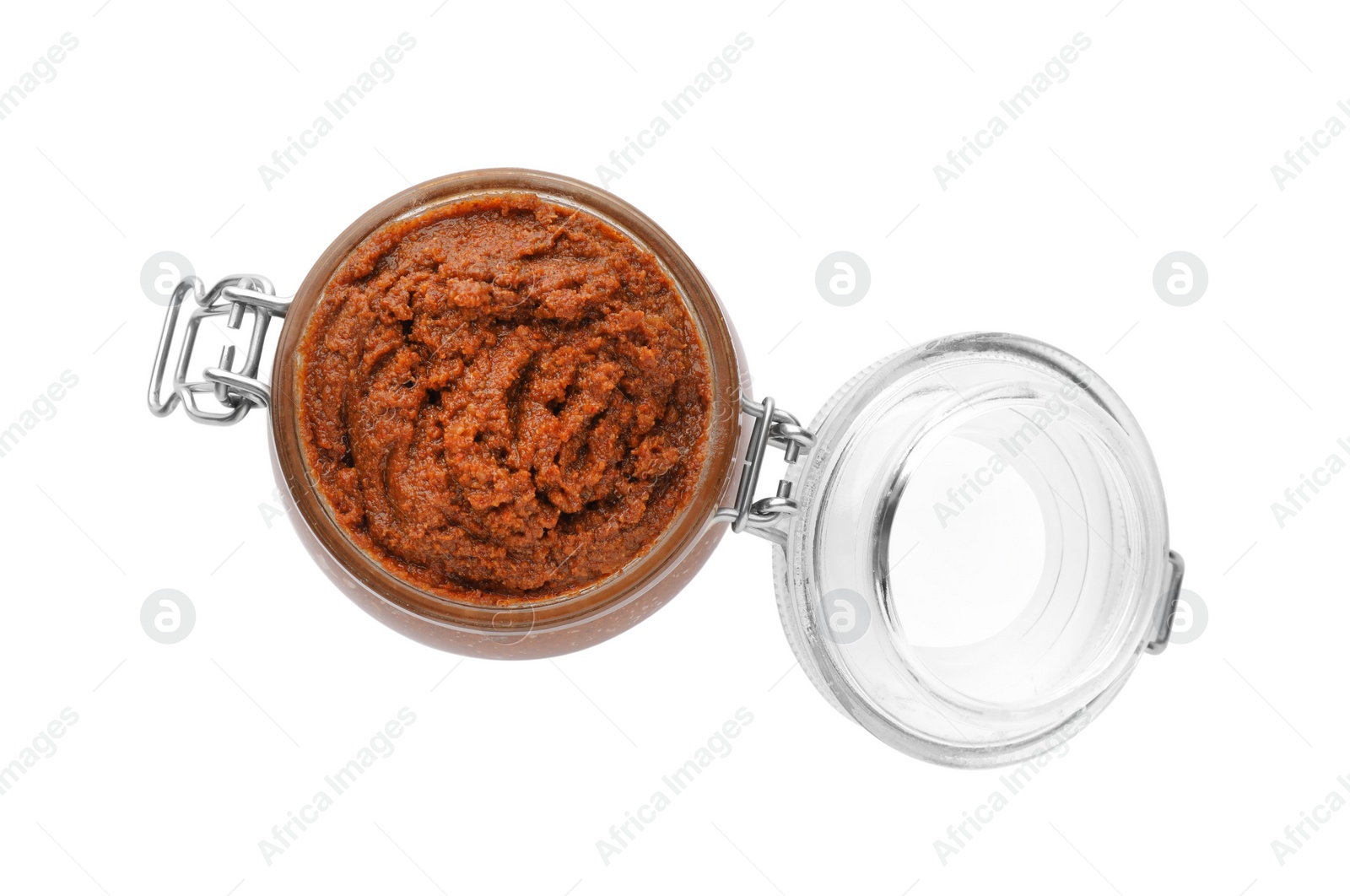 Photo of Delicious adjika sauce in glass jar isolated on white, top view