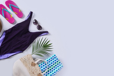 Flat lay composition with beach accessories on white background. Space for text