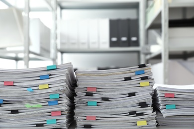 Stacks of documents with paper clips in office