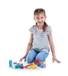 Cute child playing with colorful blocks on white background