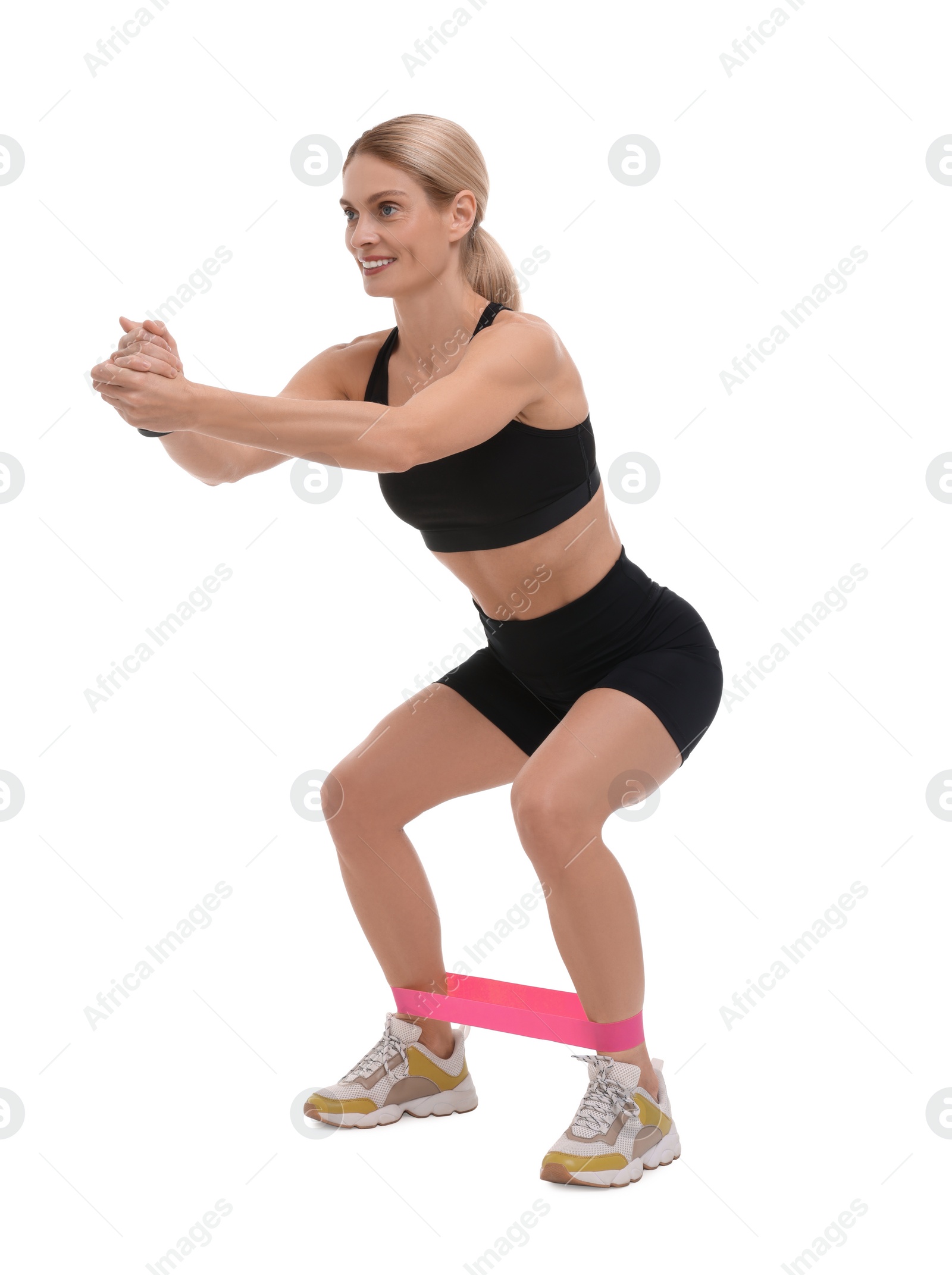 Photo of Woman exercising with elastic resistance band on white background