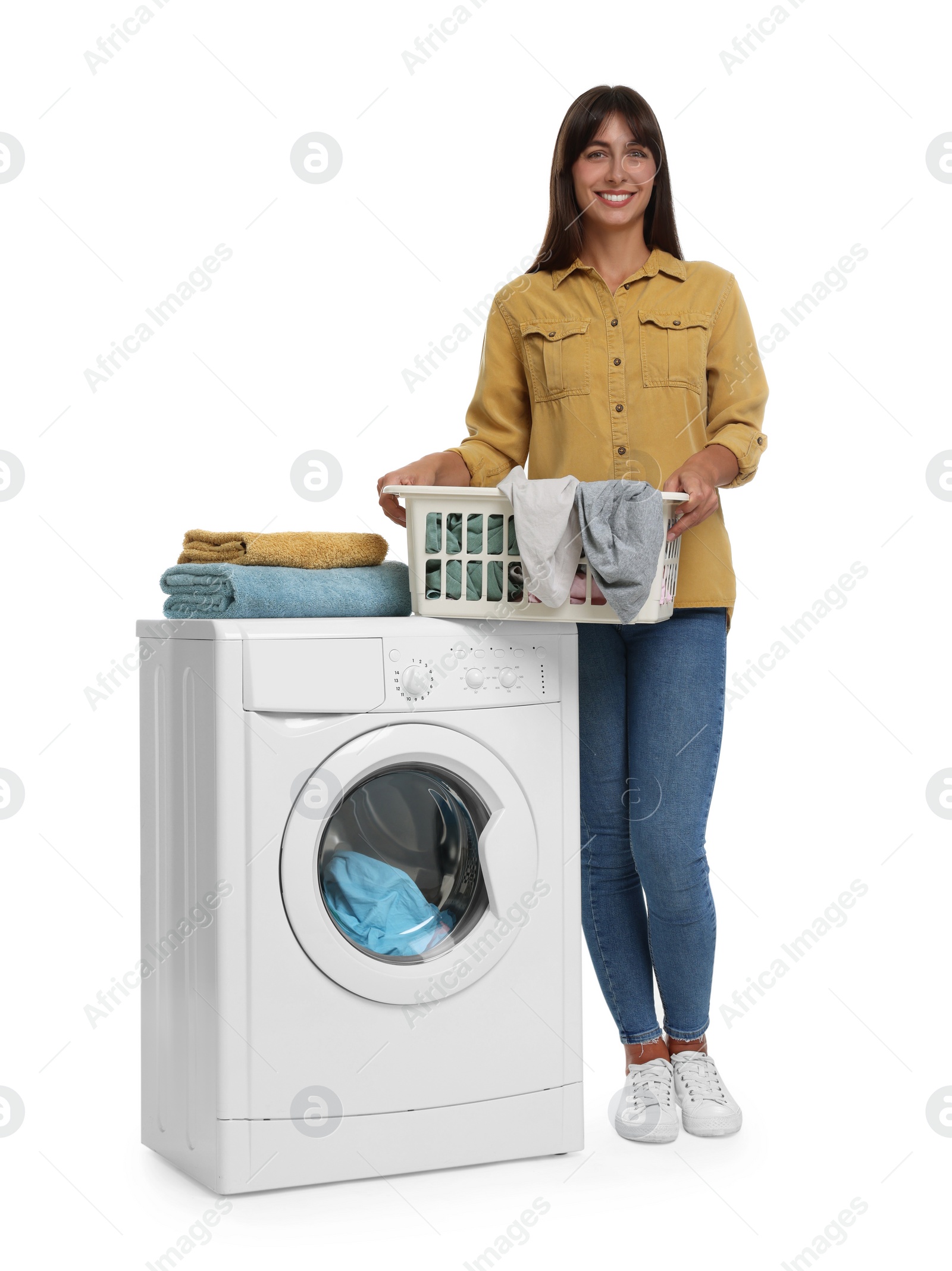 Photo of Beautiful woman with laundry basket near washing machine on white background