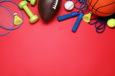 Photo of Set of different sports equipment on red background, flat lay. Space for text