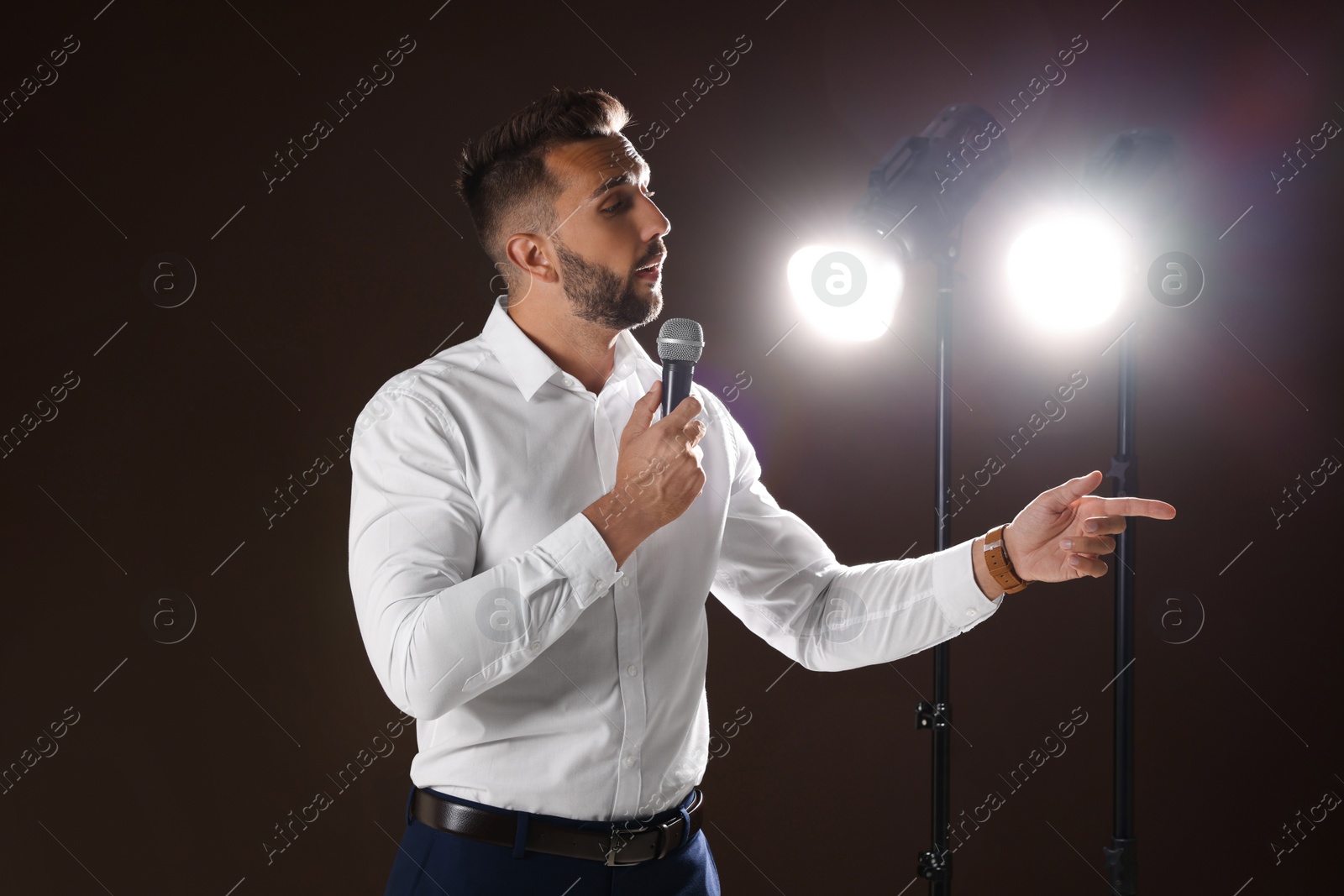 Photo of Motivational speaker with microphone performing on stage