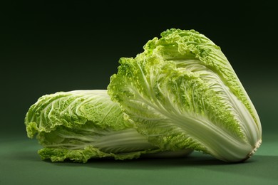 Photo of Fresh ripe Chinese cabbages on green background