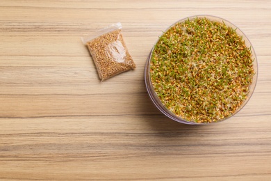 Photo of Flat lay composition with growing wheat grass on table, space for text