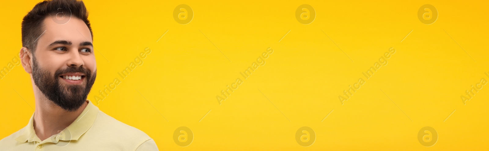 Image of Man with clean teeth smiling on yellow background, space for text. Banner design