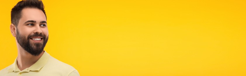 Image of Man with clean teeth smiling on yellow background, space for text. Banner design