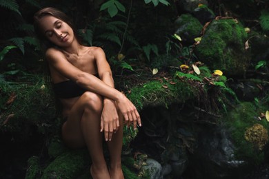 Photo of Beautiful young woman relaxing in tropical forest. Space for text