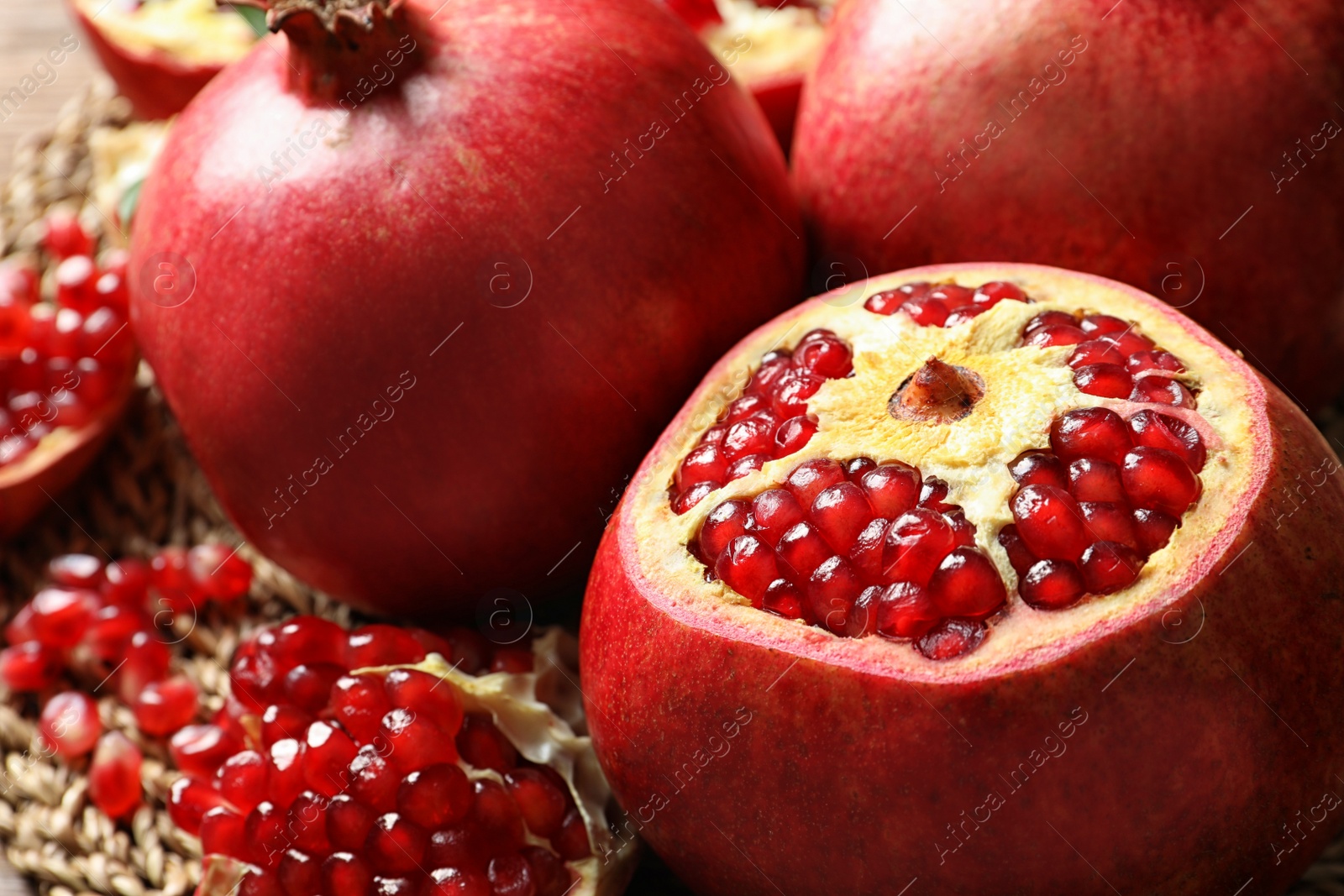 Photo of Ripe red pomegranate fruit on blurred background, closeup