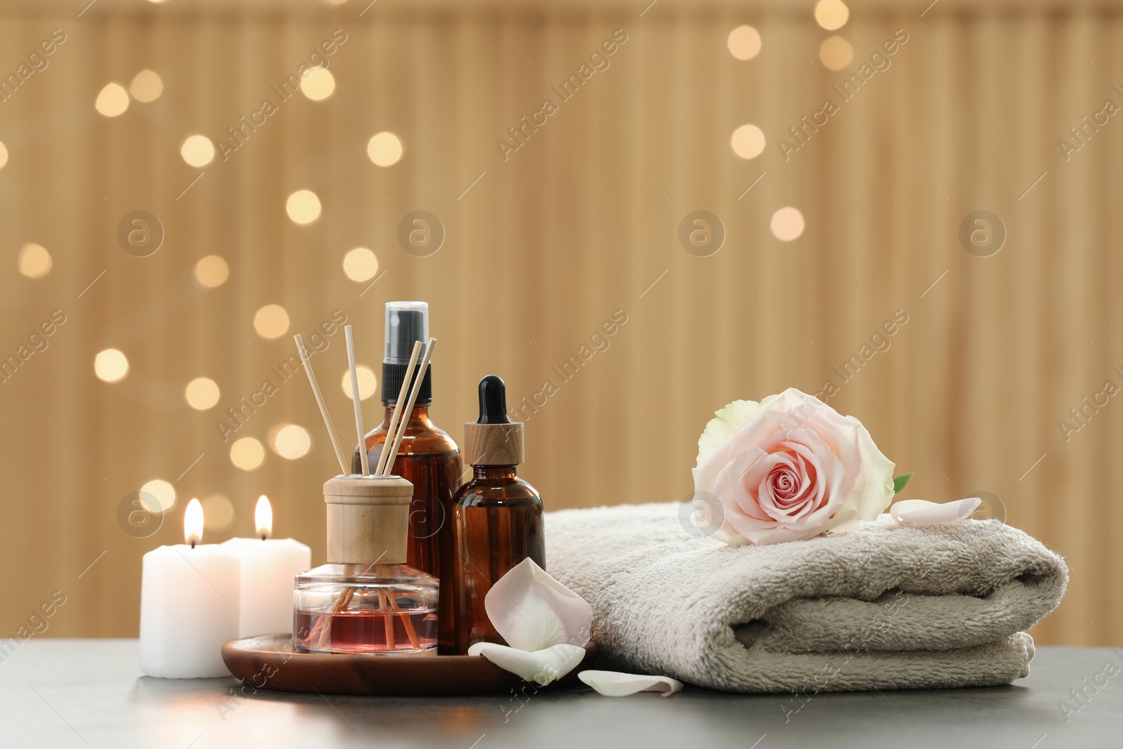 Photo of Composition with different spa products and rose flower on light table