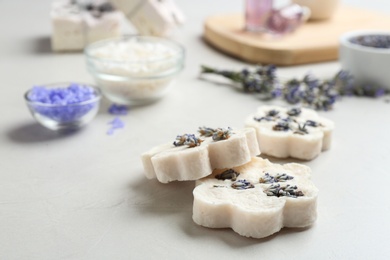 Photo of Hand made soap bars with lavender flowers on white table