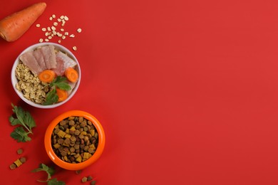 Photo of Pet food and natural ingredients on red background, flat lay. Space for text