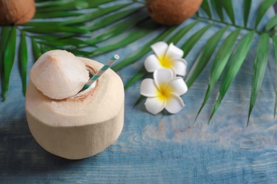 Photo of Fresh coconut drink in nut on wooden background