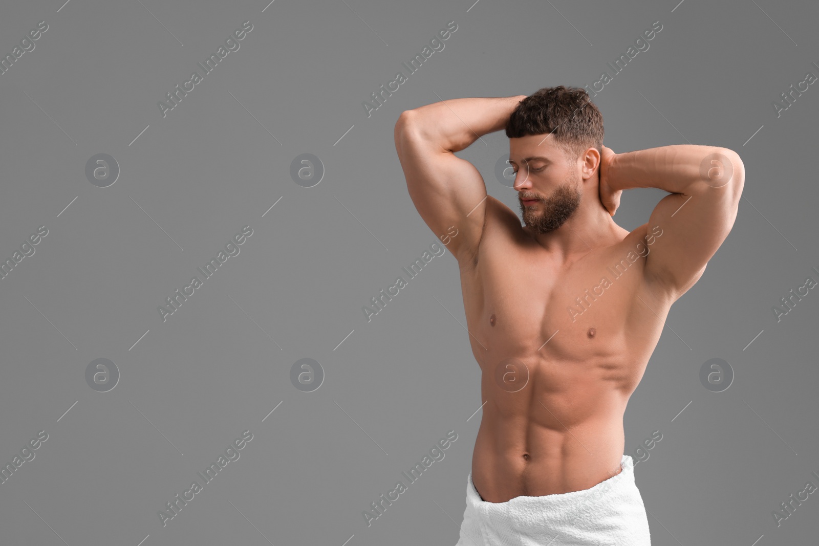 Photo of Handsome muscular man on grey background, space for text. Sexy body