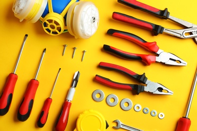 Photo of Flat lay composition with construction tools on color background