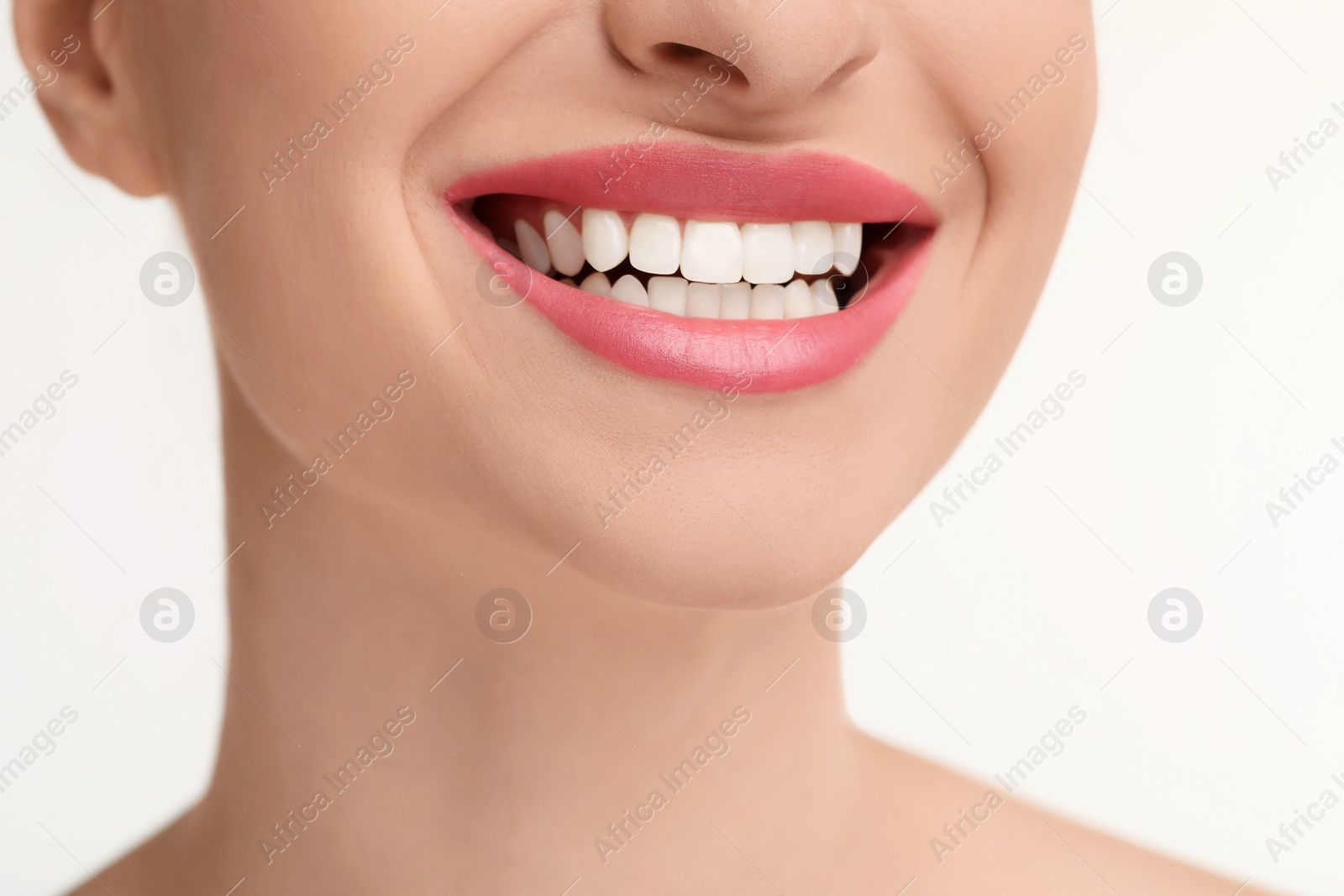 Photo of Young woman with beautiful smile on white background, closeup