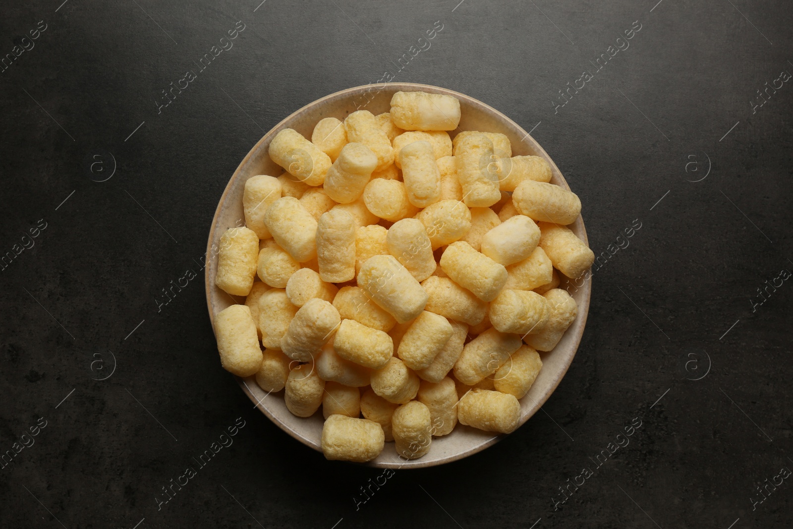 Photo of Plate of corn sticks on dark grey table, top view