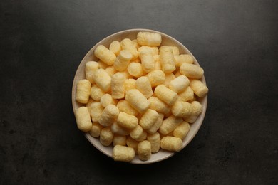 Photo of Plate of corn sticks on dark grey table, top view