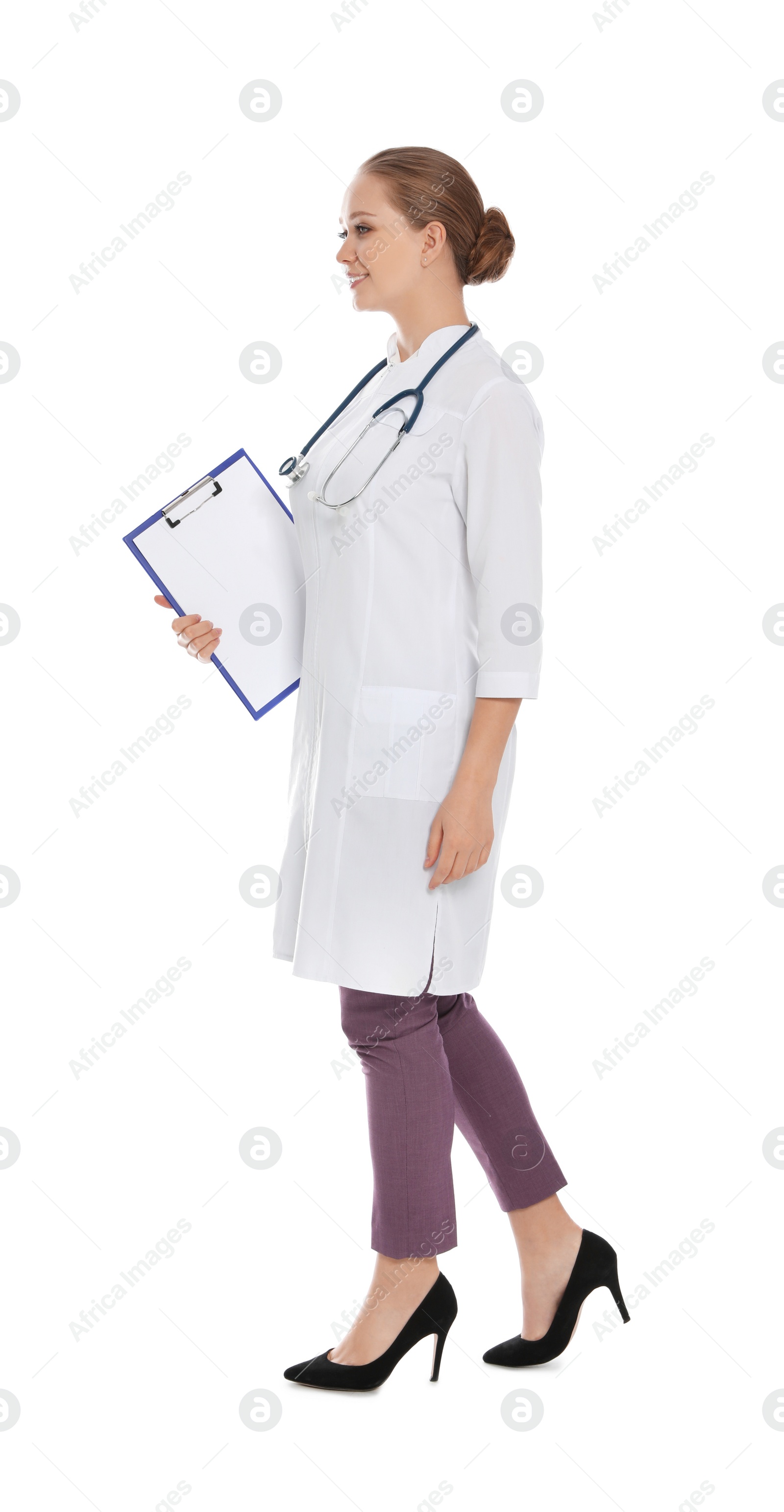 Photo of Full length portrait of medical doctor with clipboard and stethoscope isolated on white