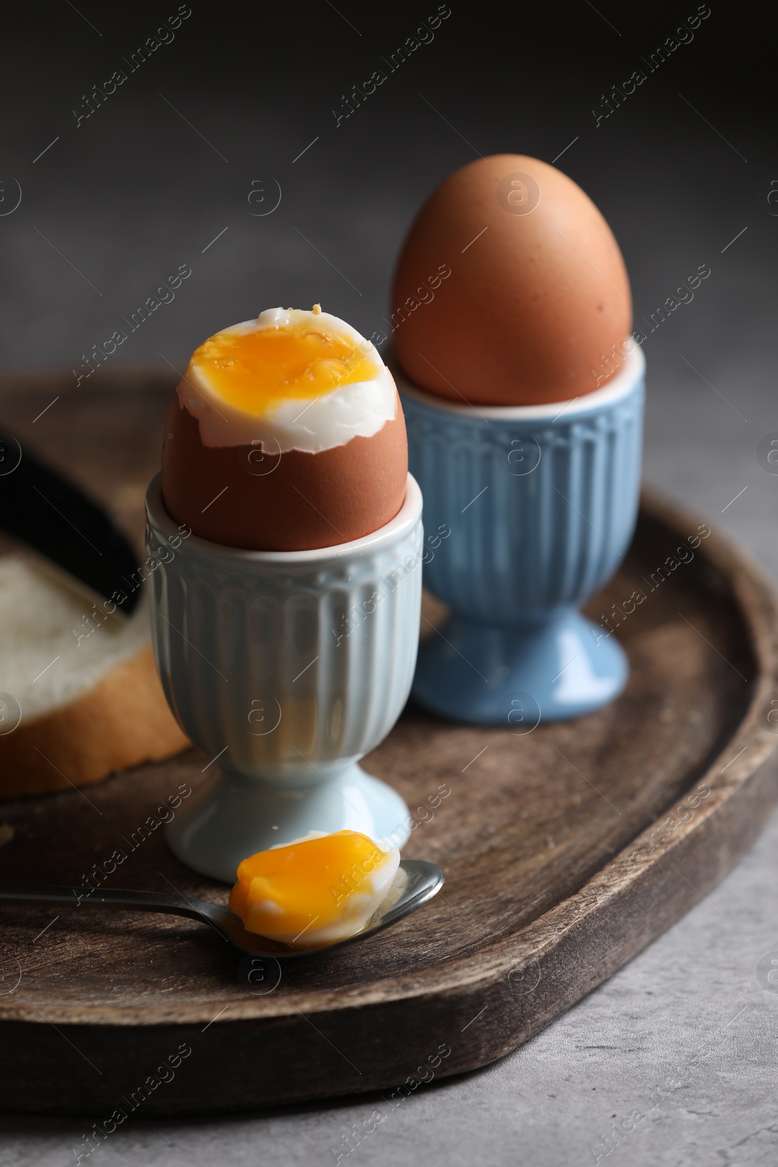 Photo of Tasty boiled chicken eggs on grey table