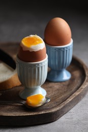 Photo of Tasty boiled chicken eggs on grey table